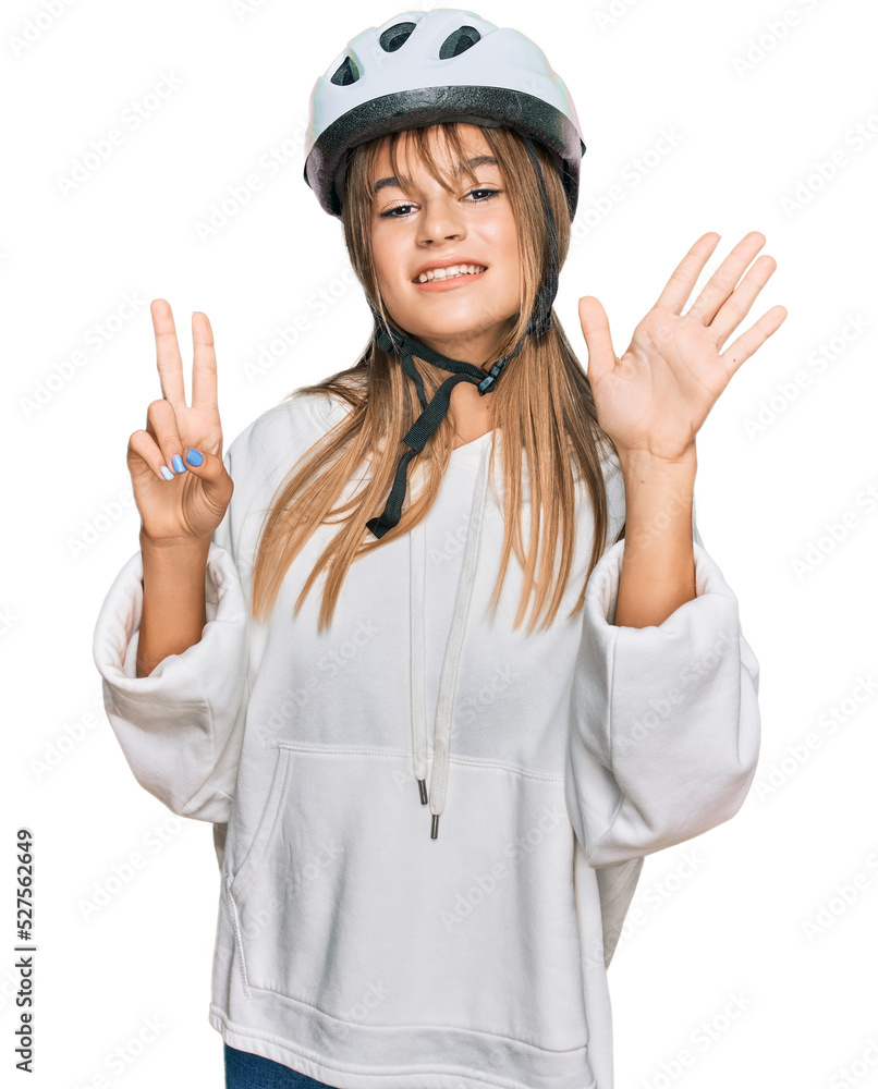 Teenager caucasian girl wearing bike helmet showing and pointing up with fingers number seven while smiling confident and happy. Teenager caucasian girl wearing bike helmet showing and pointing up with fingers number seven while smiling confident and happy.