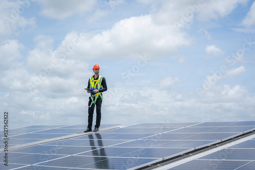 Solar power,Engineer inspect solar panels on the roof of a factory where solar panels are installed using solar energy.