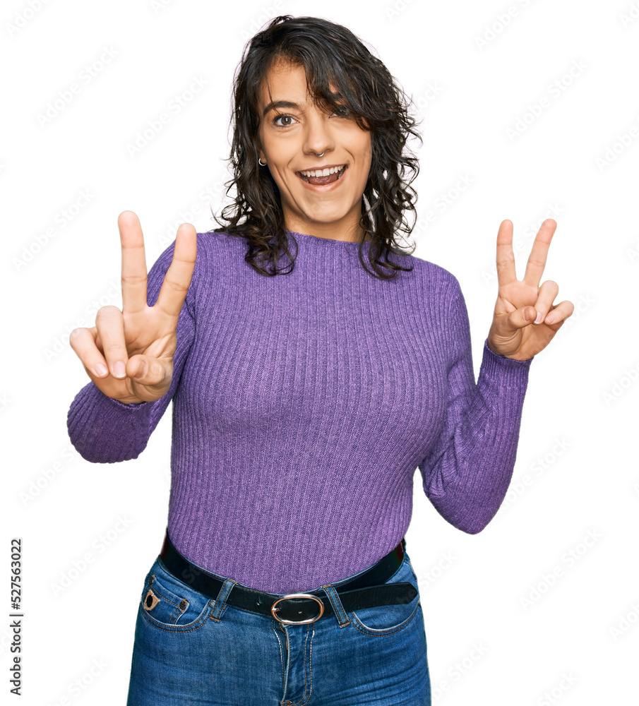 Young hispanic woman wearing casual clothes smiling looking to the camera showing fingers doing victory sign. number two. Young hispanic woman wearing casual clothes smiling looking to the camera showing fingers doing victory sign. number two.