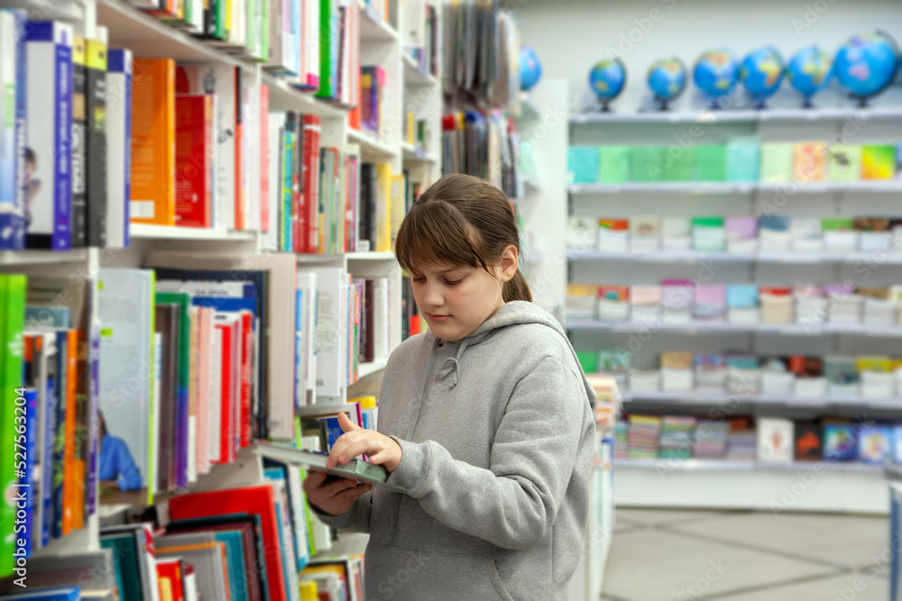 12-year-old girl between bookshelves in store