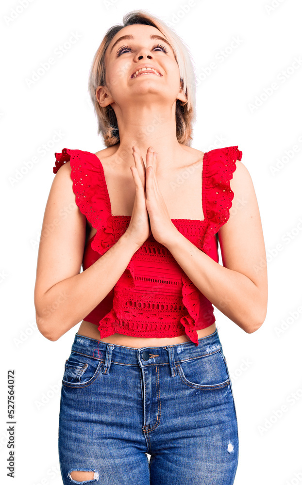 Young beautiful blonde woman wearing casual clothes begging and praying with hands together with hope expression on face very emotional and worried. begging. Young beautiful blonde woman wearing casual clothes begging and praying with hands together with hope expression on face very emotional and worried. begging.