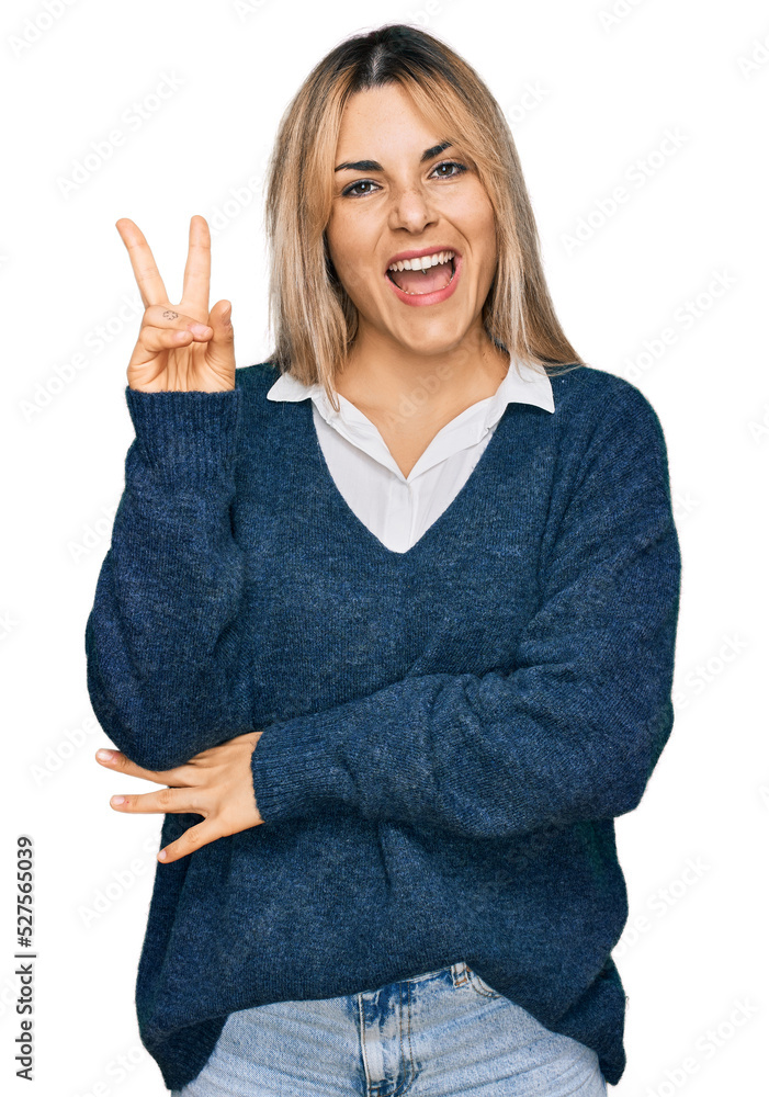 Young caucasian woman wearing casual clothes smiling with happy face winking at the camera doing victory sign with fingers. number two. Young caucasian woman wearing casual clothes smiling with happy face winking at the camera doing victory sign with fingers. number two.