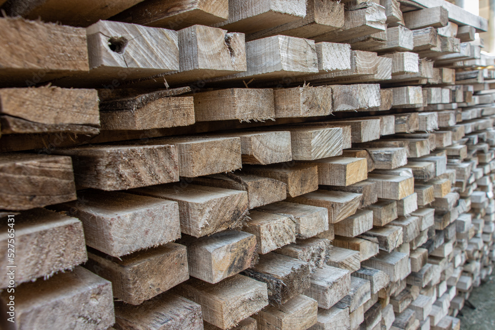 A pile of wooden planks ready for use on a construction site A pile of wooden planks ready for use on a construction site