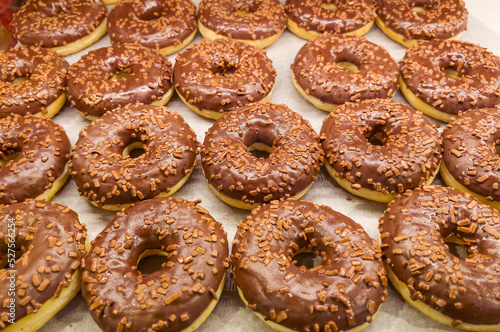 Donuts with chocolate glaze in bakery shop