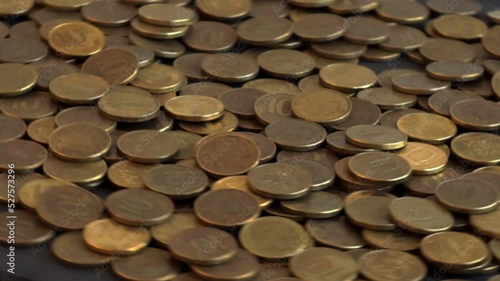 Metal coins of the Russian ruble fall from above on coins rotating in a circle in slow motion. Ten rubles. Russian money. The national currency of the Russian Federation. Money exchange rate. Metal coins of the Russian ruble fall from above on coins rotating in a circle in slow motion. Ten rubles. Russian money. The national currency of the Russian Federation. Money exchange rate.