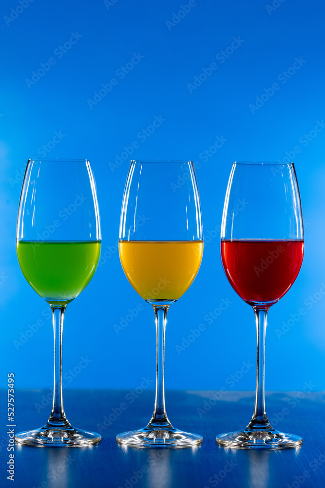3 color drink in wine glass