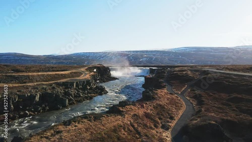 Icelandic river and waterfall with mountains on the background drone show in 4K