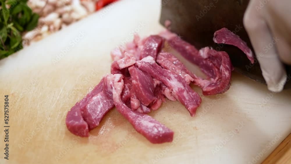 Hand with Glove Use Knife to Slice Beef into Pieces on White Chopping Board, Close Up Hand with Glove Use Knife to Slice Beef into Pieces on White Chopping Board, Close Up