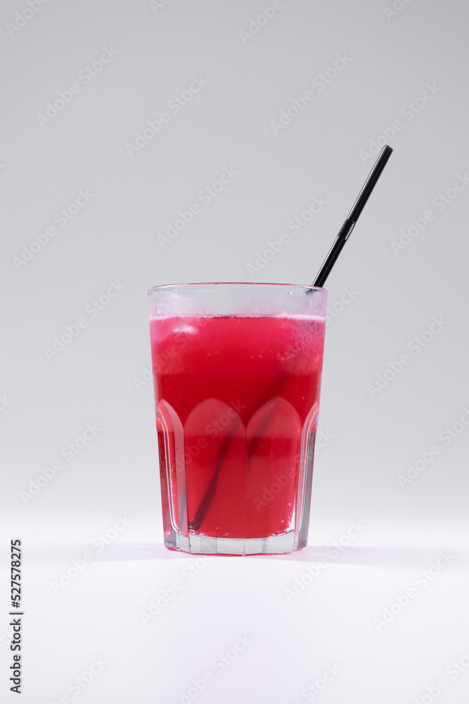 fresh cold fruit drink with red grape juice, ice, straw isolated fresh cold fruit drink with red grape juice, ice, straw isolated