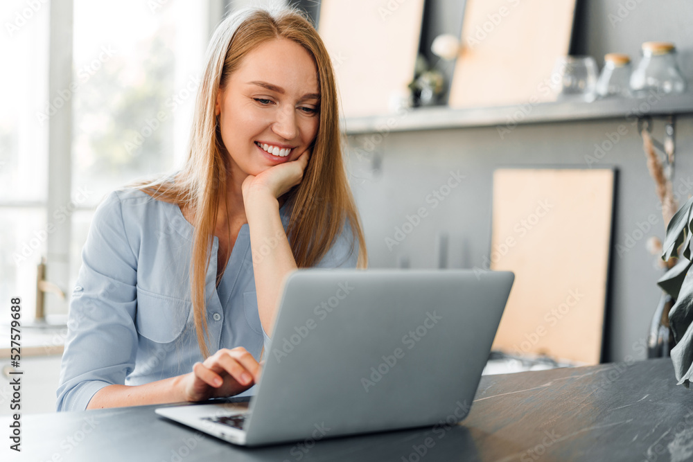 Young female entrepreneur working on a laptop at home Young female entrepreneur working on a laptop at home