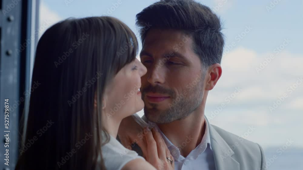 Closeup romantic couple flirting ocean view hotel. Playful woman looking at man Closeup romantic couple flirting ocean view hotel. Playful woman looking at man