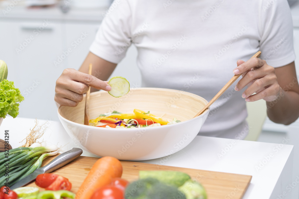 Eat healthy food for good wellness health concept. Woman cooking salad menu with fresh organic vegetables Eat healthy food for good wellness health concept. Woman cooking salad menu with fresh organic vegetables