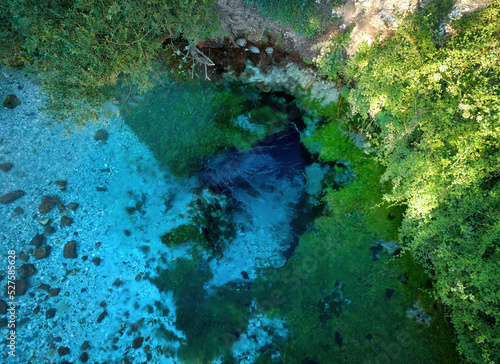 Blue Eye, deep karst cave spring of the Bistricë River, Albania. Clear, blue-green, cool water, picturesque view of real pure nature, aerial, perpendicular view. Travelling in Albania.