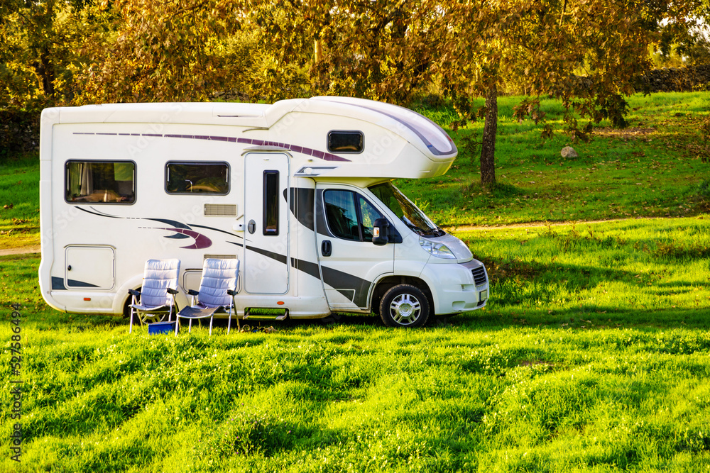 Camper and chairs on nature