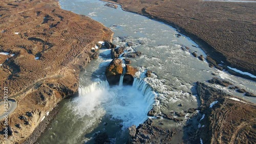 Icelandic river and waterfall with mountains on the background drone show in 4K