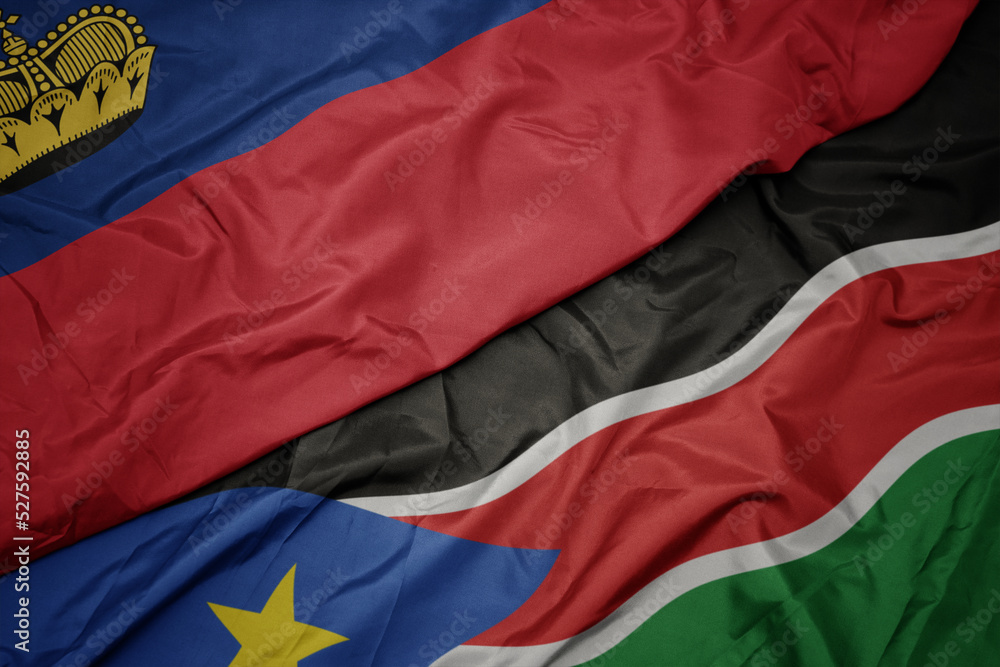 Fototapeta premium waving colorful flag of south sudan and national flag of liechtenstein.
