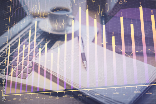 Double exposure of forex chart drawing and desktop with coffee and items on table background. Concept of financial market trading