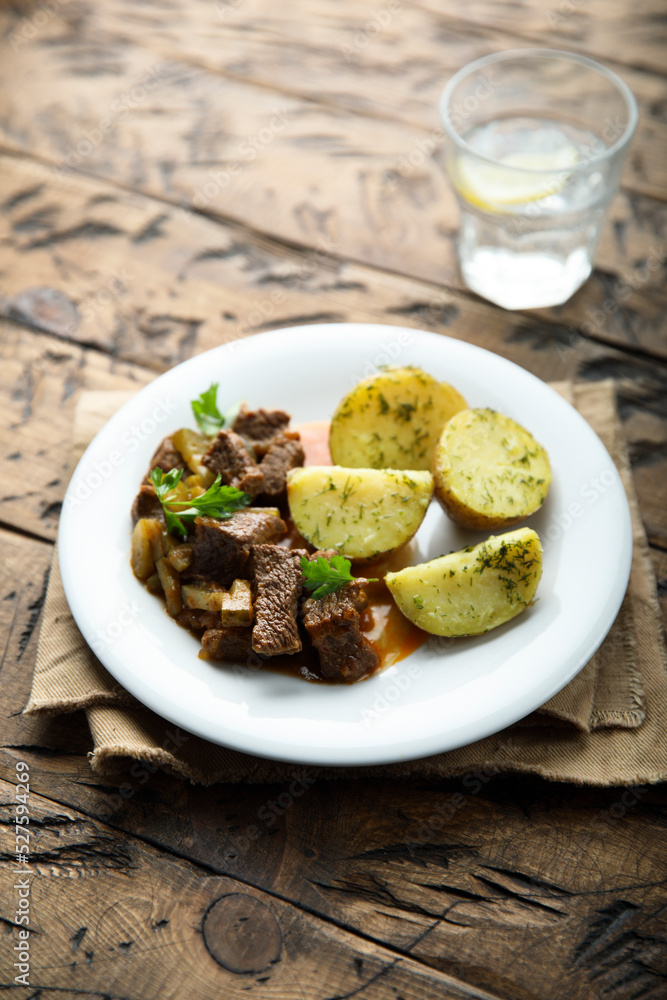 Homemade beef ragout with pickles and potato