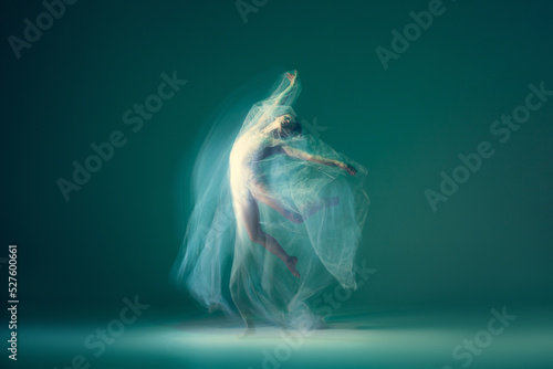 Leinwand Poster Graceful ballet dancer dancing with white cloth, fabric isolated on green background