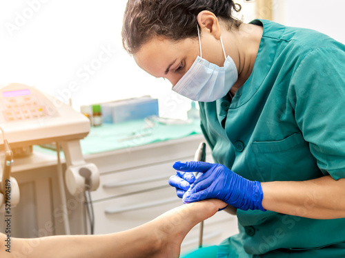 Tableau sur toile Female podiatrist doing chiropody in her podiatry clinic