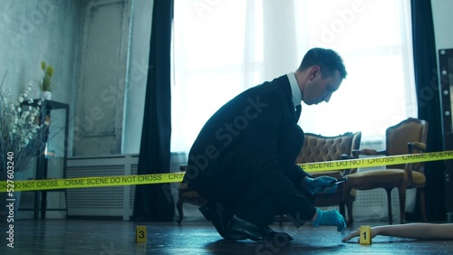 Detective Collecting Evidence in a Crime Scene. Forensic Specialists Making Expertise at Home of a Dead Person. Homicide Investigation by Professional Police Officer.