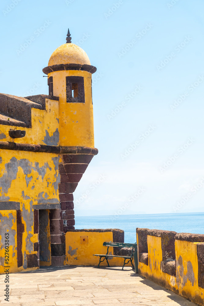 Detail of the yellow watchtower at the Forte de Sao Tiago on the beach of Funchal. Madeira