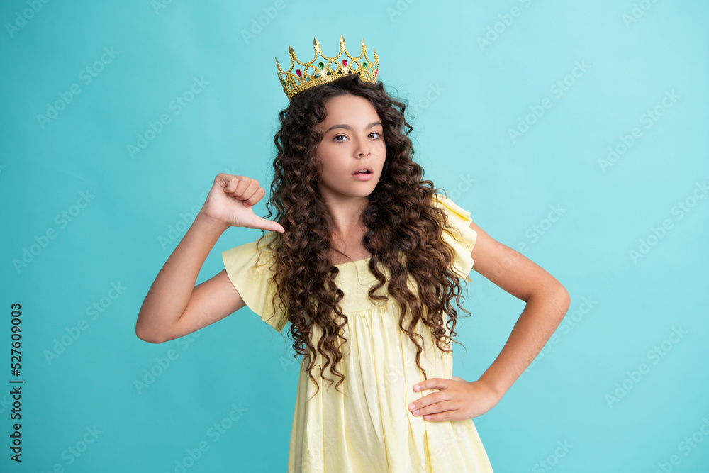 Teen child in queen crown isolated on blue background. Princess girl in tiara. Teenage girl wear diadem. Teen child in queen crown isolated on blue background. Princess girl in tiara. Teenage girl wear diadem.