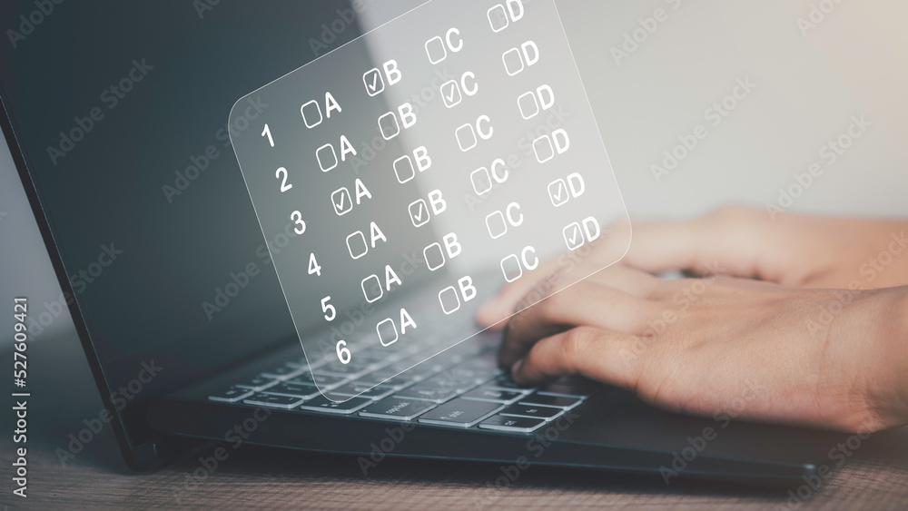 Students taking online exams by laptop. Virtual test or questionnaire ...