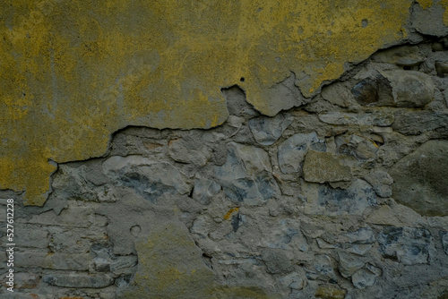 old wall background partly yellow and partly brick closeup. Textured stone. Copy space. 