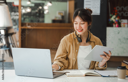 Asian businesswoman working on laptop computer Look for job online, freelance looking and typing on notebook on table, lifestyle of woman studying online