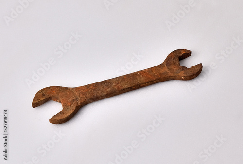 Rusty wrench on a white background close-up