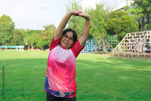 Middle-aged Asian women warming up before exercise. Fitness concept of middle-aged people who use their free time after work to exercise for good health.