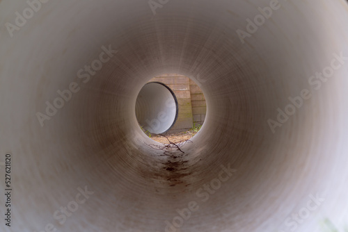 view through a large white pipe to the entrance to the next pipe elements from an interactive playground