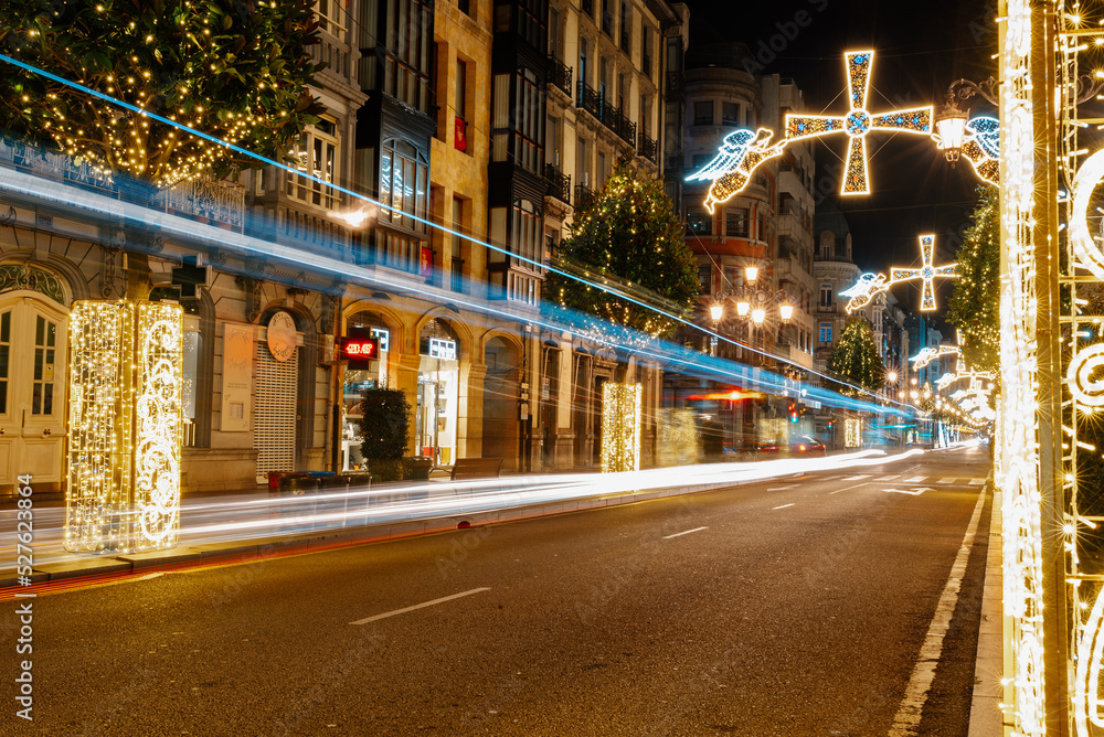 urban landscape illuminated with Christmas decorations and trails of passing vehicles. Oviedo, Asturias, Spain