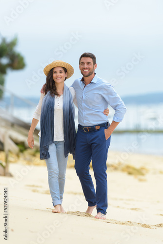 embracing couple walking on the beach