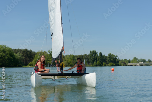 young woman and man preparing for sailing together