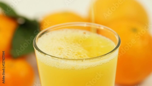 This refreshing stock photo showcases juicy oranges and freshly squeezed juice on a clean white background, perfect for health, wellness, and food-related content.