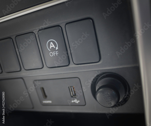 Auto Start and Stop button automatically shuts off the engine when the vehicle comes to a full stop. © panupol