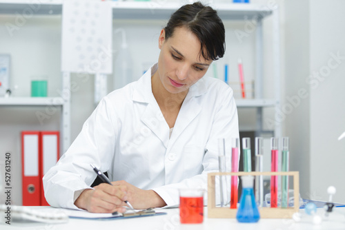 woman writing notes in the lab