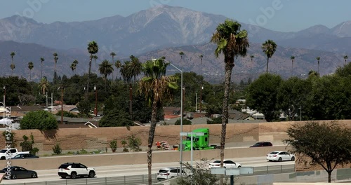 Palm tree and San Gabriel Mountain framed view of the 10 Freeway as runs through West Covina, California, USA. photo