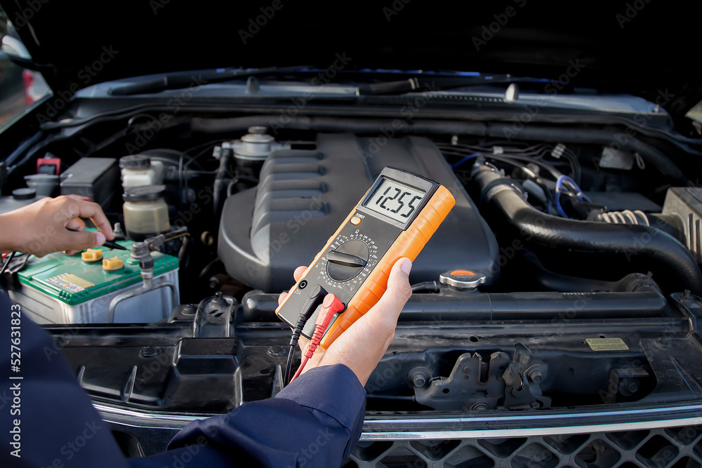 Technicians inspect the car's electrical system.