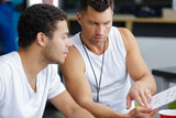 two men exercising in gym