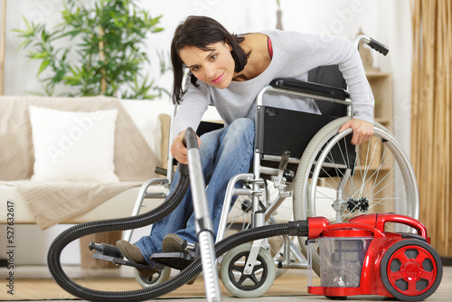 disable woman using a vacuum cleaner © auremar