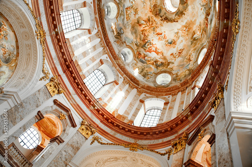 Vienna, Austria - August 27, 2022: Sacred building with a mighty dome. Karlskirche in Wien from the inside. Close up of the beautiful fresco on the ceiling photo
