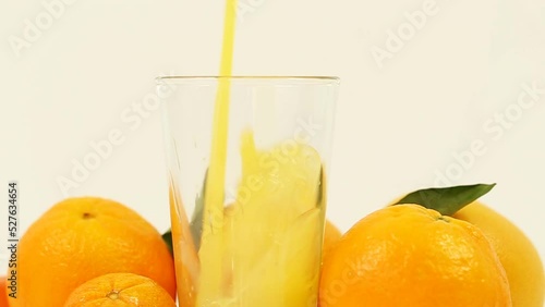 This refreshing stock photo showcases juicy oranges and freshly squeezed juice on a clean white background, perfect for health, wellness, and food-related content.