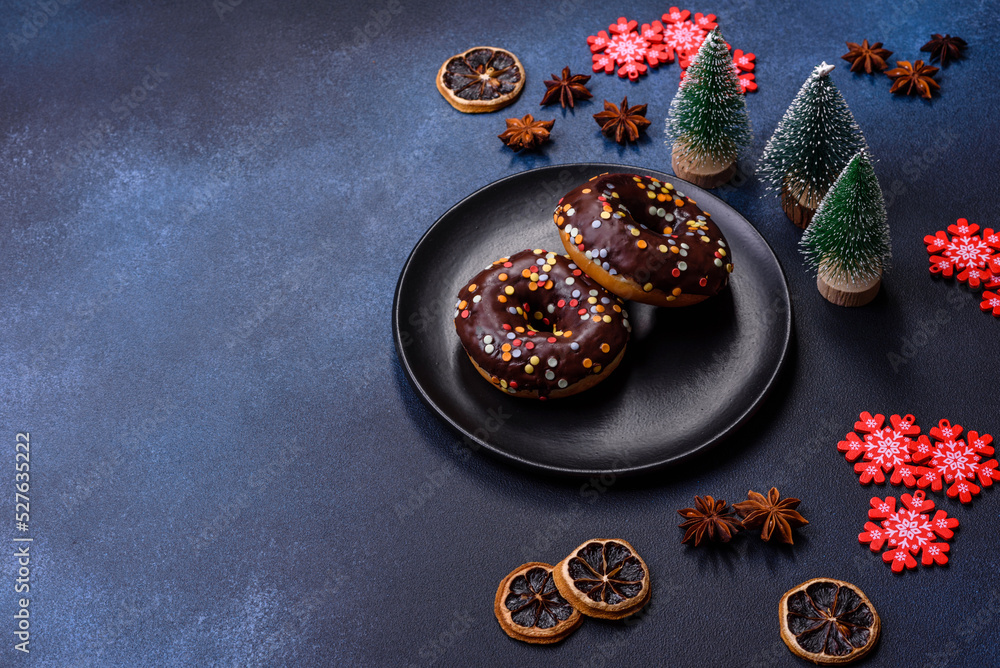 Pastries concept. Donuts with chocolate glaze with sprinkles, on a dark concrete table