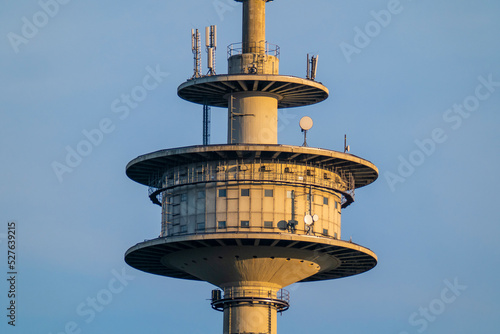 Close-up of the platform of a TV tower in front of a blue sky photo