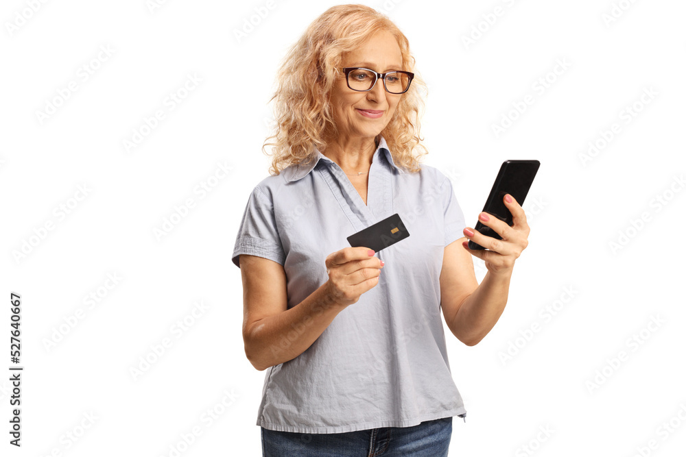 Mature woman using a smartphone and a credit card Mature woman using a smartphone and a credit card