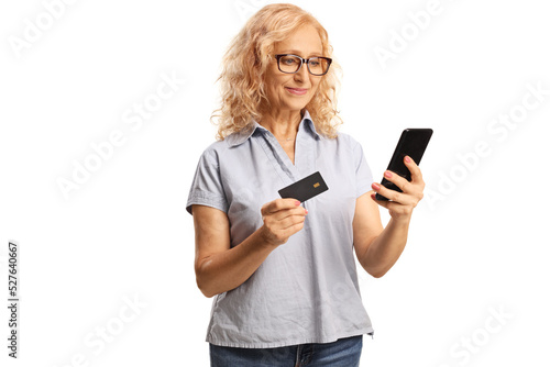 Mature woman using a smartphone and a credit card