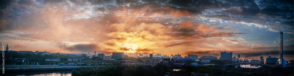 Dramatic sunrise sky over urban landscape of Glasgow Scotland